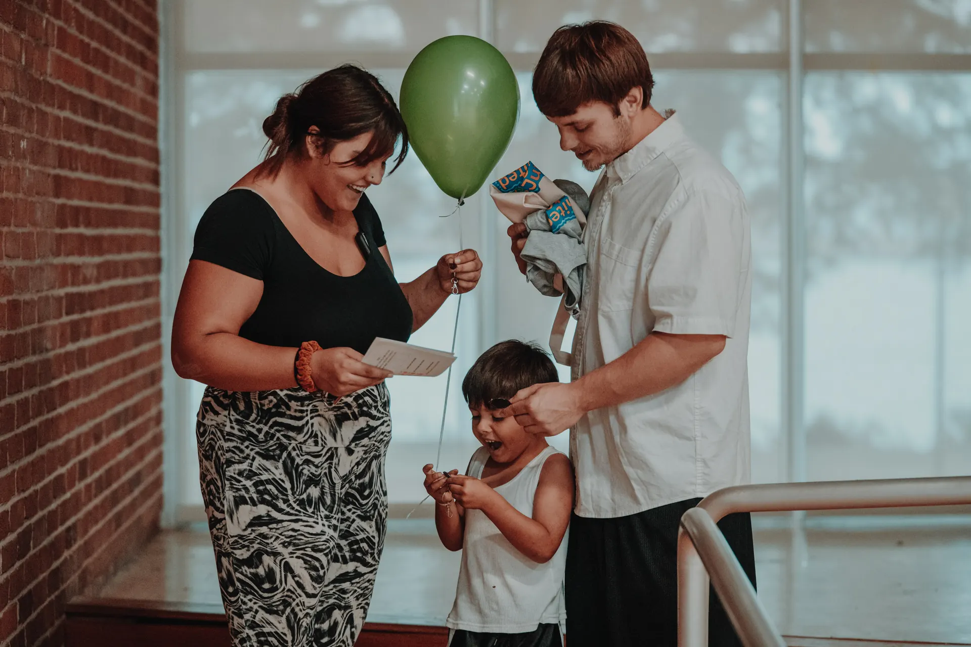 A family with a balloon and welcome bag at Community Day