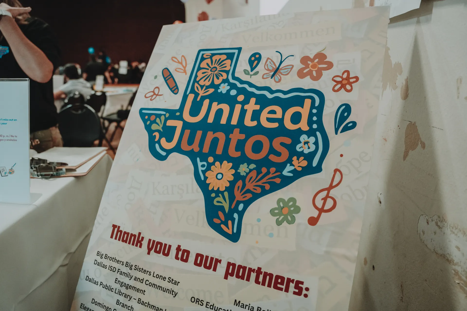 A hand-painted United Juntos Texas poster thanking participating organizations
