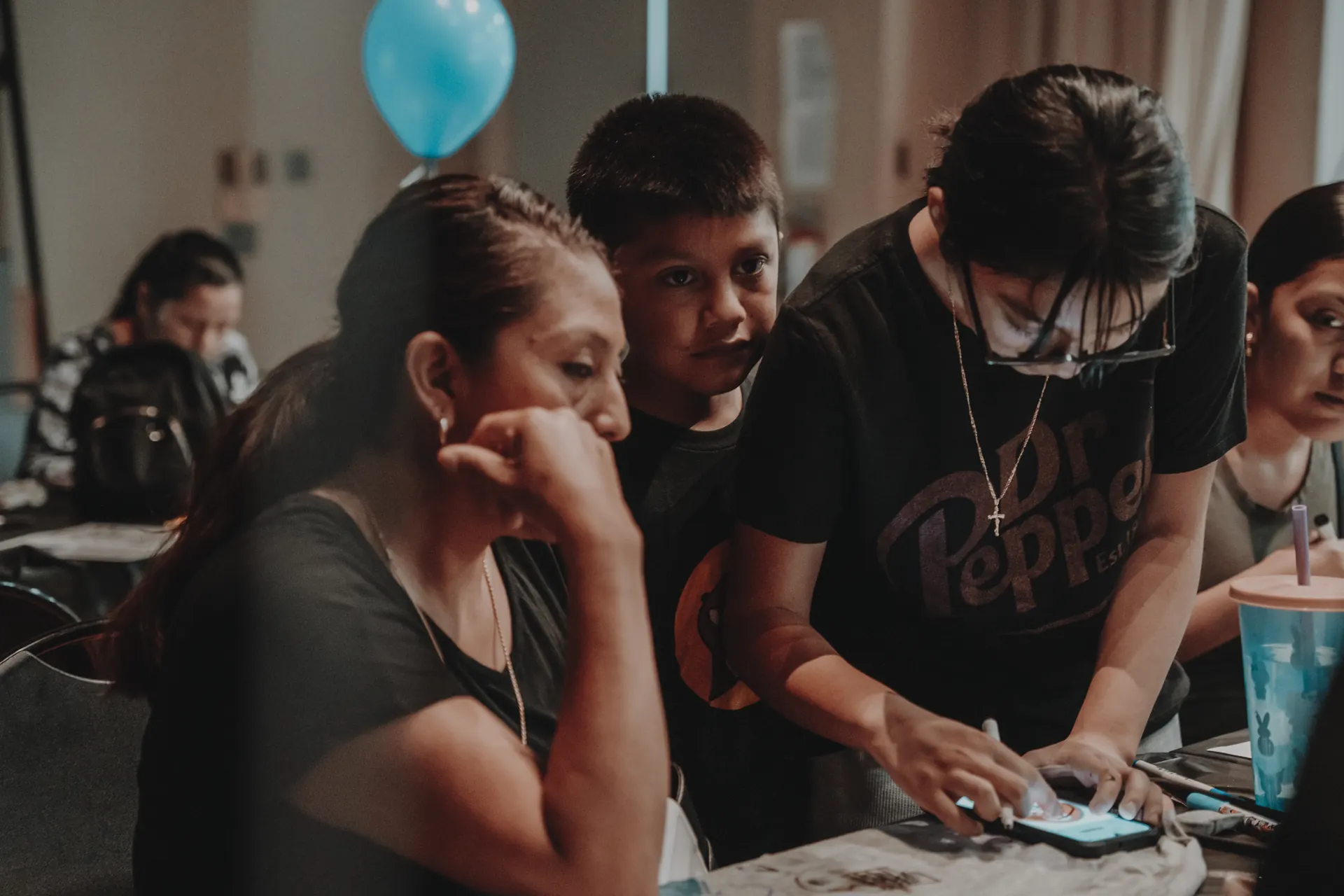 A family signing up with a volunteer at Community Day
